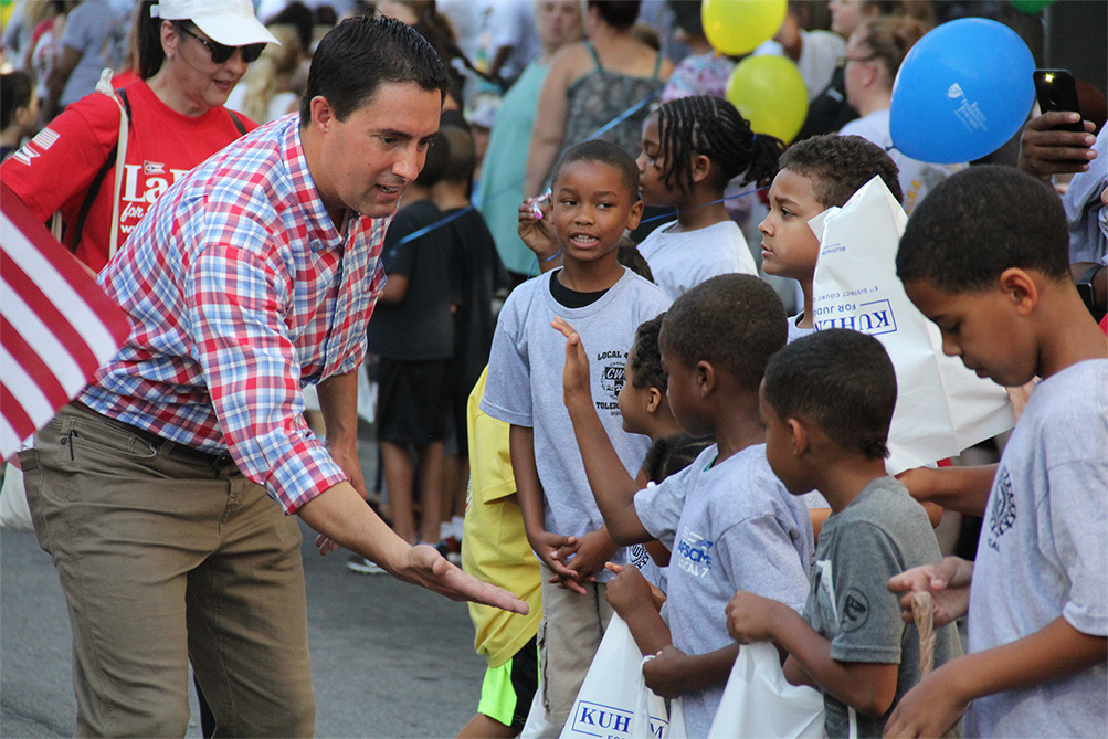 Frank LaRose during a parade saying hello to kids