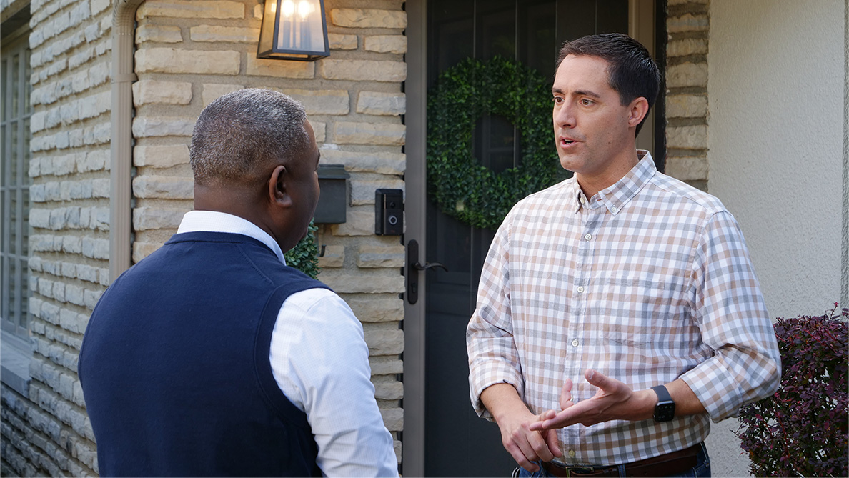 Frank LaRose talking with a voter outside of a home