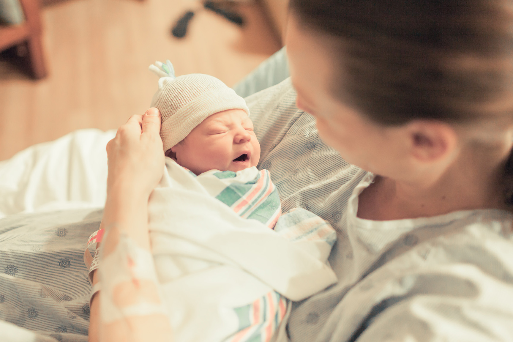 A woman holding a newborn baby